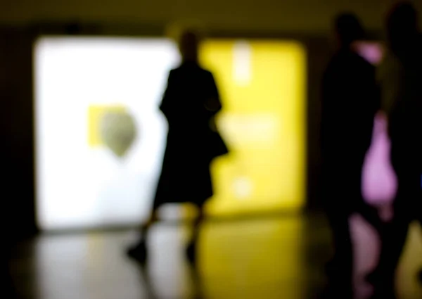 Lens blur image of subway with moving human silhouette.