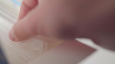 Male hand pulls out an individually packaged protective medical mask from a box.