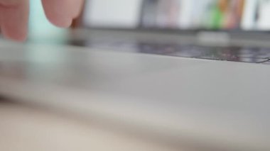 Mans el, modern dizüstü bilgisayarın özel çoklu dokunmatik jestlerini kullanır. Sığ alan derinliği, yakın çekim, denge atışı. Yüksek kalite 4k görüntü.