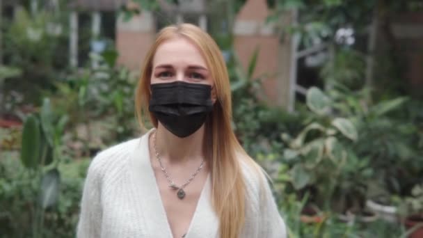 Beautiful Caucasian Woman Black Medical Mask White Knitted Sweater Standing — Vídeo de Stock