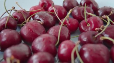 Red fresh ripe Ukrainian cherries on a blue plate. Fresh berries, eco farm harvest. Closeup view.