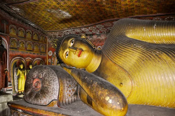 Lying gold Buddha in Cave temple in Dambulla Srí Lanka