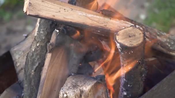 Close-up van gehakte brandhout branden. Vuur op hout, het verbranden van gehakt hout in een stenen haard. Vuur van vuur. Brandende oranje vlam op het hout. Zeer hete houtskool branden in een grill 4k — Stockvideo