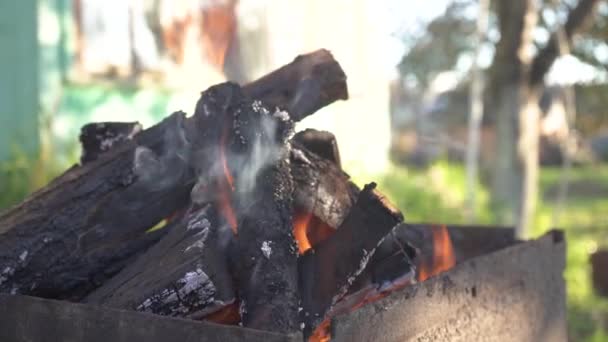 Detailní záběr hořícího štípaného dřeva. Oheň na dřevě, pálení sekaného dřeva v kamenném krbu. Ohnivý tábor. Hořící oranžový plamen na dřevě. Velmi horké dřevěné uhlí hoří v grilu 4k — Stock video