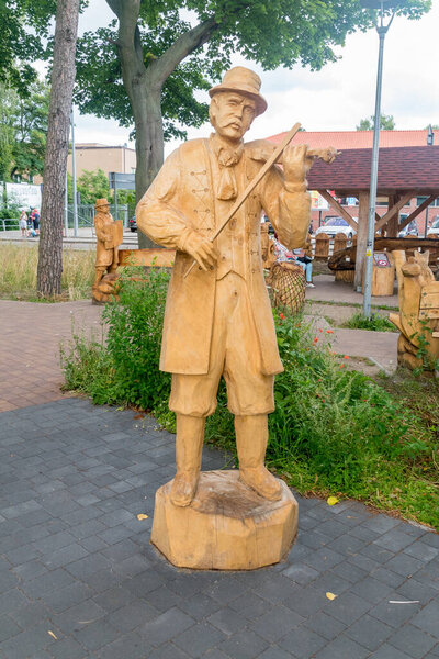 Hel, Poland - July 20, 2021: Wooden sculpture of man on Kashubian Sculpture Gallery in Hel.