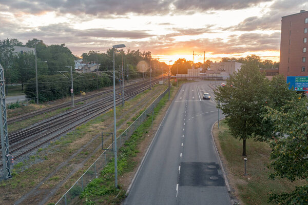 Turku, Finland - August 5, 2021: Sunrise on Helsinginkatu street with railway tracks.
