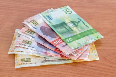 Tahta masaya Norveç kronu (NOK) banknotları.