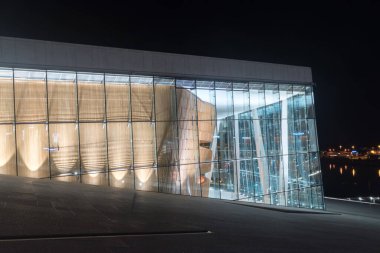 Oslo, Norway - September 23, 2021: Illuminated Norwegian Opera and Ballet (Norwegian: Operahuset) at night.