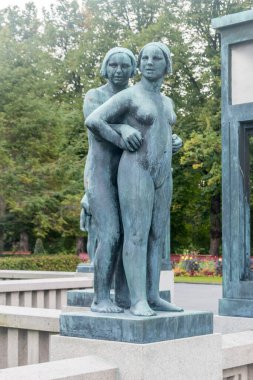 Oslo, Norway - September 24, 2021: Sculpture in Frogner Park (Norwegian: Frognerparken) at cloudy day. Bridge with statues.