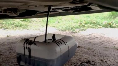 Car oil drain from engine. Oil drain from motor engine.