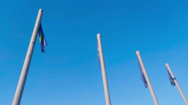 National flags of Kosovo waving on blue sky.
