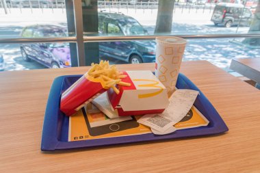 Belgrade, Serbia - June 7, 2022: Mcdonald menu with Grand Dupli Cheese Jalapeno burger, french fries and Coca-Cola.