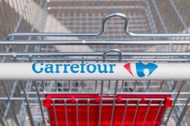 Oradea, Romania - June 9, 2022: Logo and sign of Carrefour on shopping cart. Carrefour is French multinational retail and wholesaling corporation.