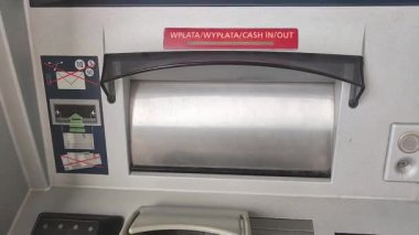 Pruszcz Gdanski, Poland - June 30, 2022: Man hand take Polish money from ATM.