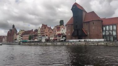 Gdansk, Poland - July 15, 2022: Timelapse of Motlawa river in old town with the oldest medieval port crane (Zuraw) in Europe.