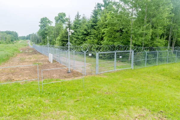Border fence with barbed wire on the Russia and Lithuania border. Fence on Lithuania site.