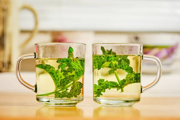 Mint green herb tea in glass cup