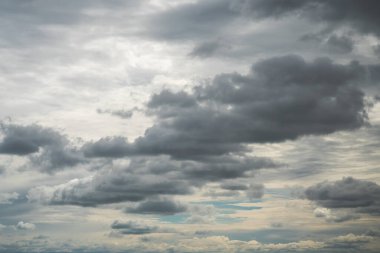 Arkaplanı ya da arkaplanı aşağıdaki koyu beyaz kümülüs bulutlarıyla ve yukarıdaki altostratus bulutlarıyla dramatik mavi gökyüzü ile değiştir.