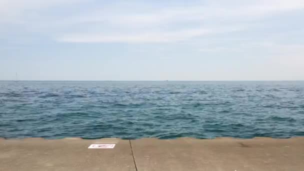 Slow Panning Clip Blue Waters Lake Michigan Corrugated Concrete Shoreline — 图库视频影像