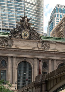A beautiful New York City view of Grand Central Terminal from below the Park Avenue bridge leading up to the front entrance of the historic building.