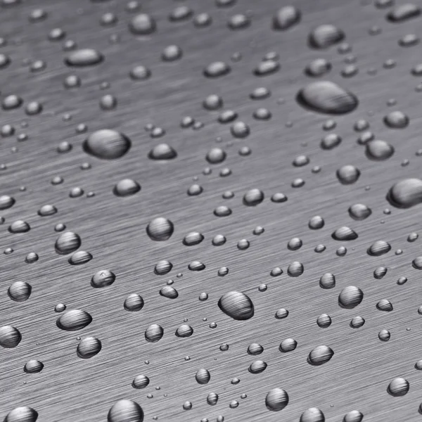 Beading nanotechnology lotuseffekt metal seal rain water drops roll off h2o surface — Stock Photo, Image