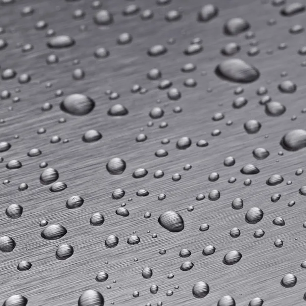 Beading nanotechnology lotuseffekt metal seal rain water drops roll off h2o surface — Stock Photo, Image