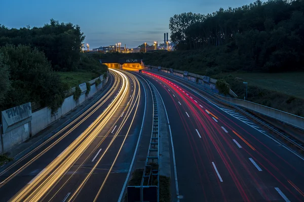 Long time exposure freeway cruising car light trails streaks of light speed highway tunnel — Stock Photo, Image