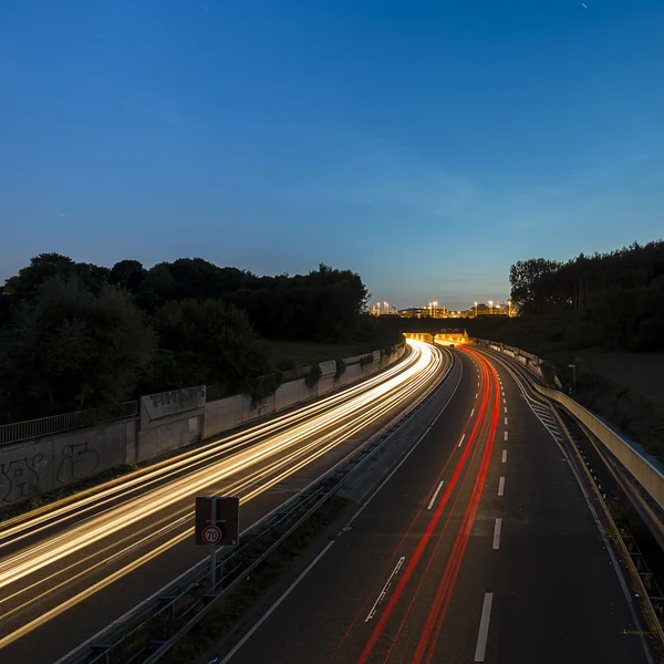 Long time exposure freeway cruising car light trails streaks of light speed highway tunnel — Stock Photo, Image