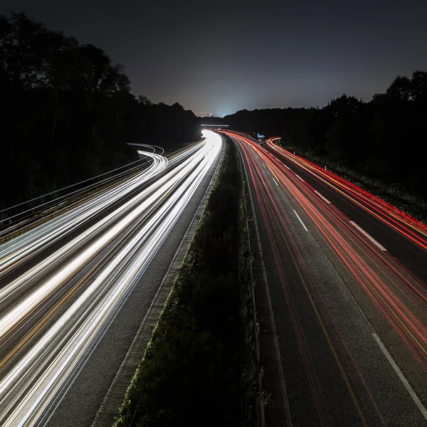 Lungo tempo di esposizione autostrada luna crociera auto sentieri leggeri striature di autostrada della velocità della luce — Foto Stock