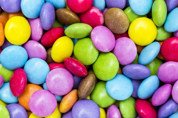 Chocolade linzen, smarties snoep chocolade suikerwerk veelkleurige kleurrijke halloween verjaardag — Stockfoto
