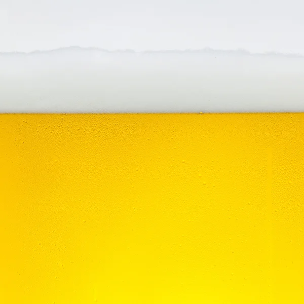 Beer dew drops beer froth glass gold crown foam wave oktoberfest condensing brewery restaurant pils — Stock Photo, Image