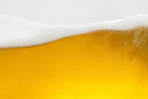 Beer dew drops beer froth glass gold crown foam wave oktoberfest condensing brewery restaurant pils — Stock Photo, Image