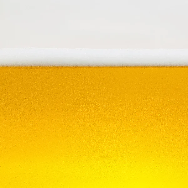 Beer dew drops beer froth glass gold crown foam wave oktoberfest condensing brewery restaurant pils — Stock Photo, Image