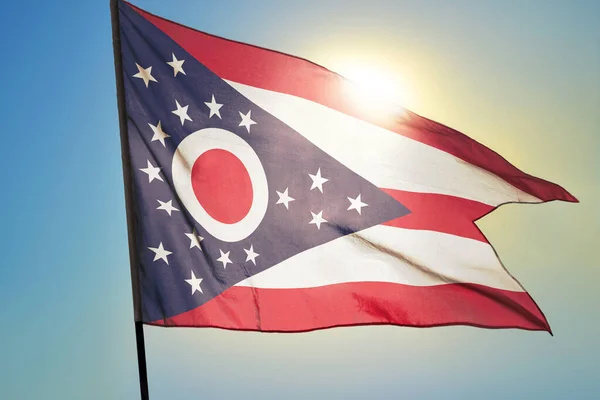 Ohio state of United States flag waving on the wind in front of sun