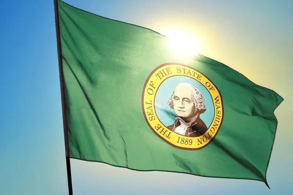 Washington state of United States flag waving on the wind in front of sun