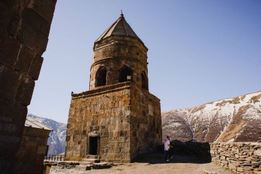 Mavi gökyüzü ve kilisesi olan güzel bir dağ manzarası. Stepantsminda Georgia 'da Kazbek Dağı' nın karla kaplı zirvesi