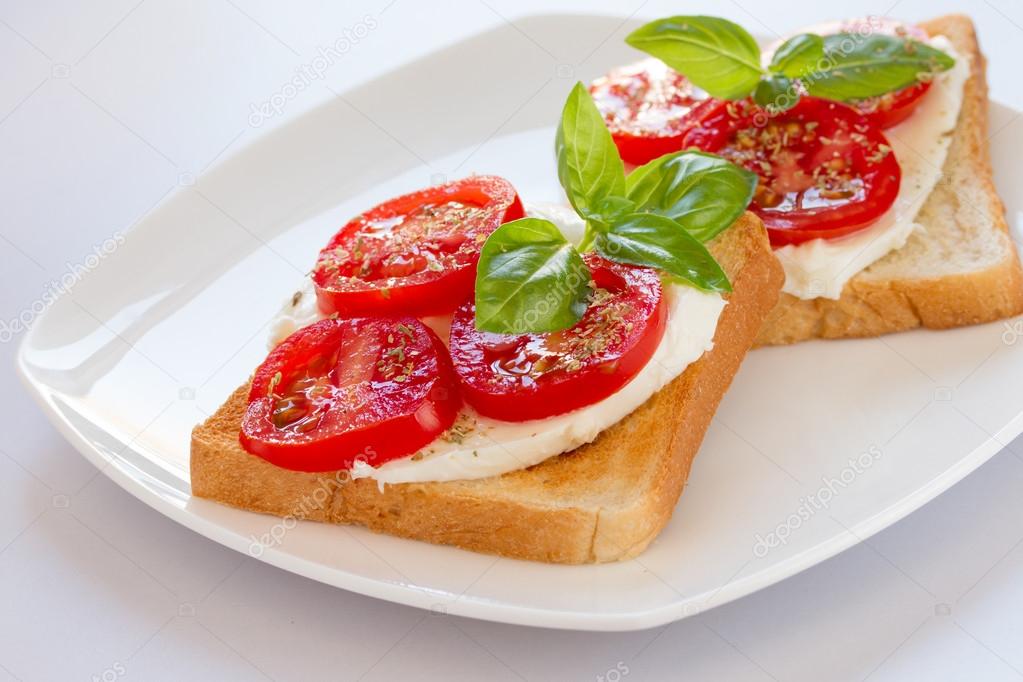 Bread with mozzarella tomatoes and basil
