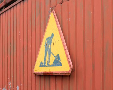 Sign man at work on iron door