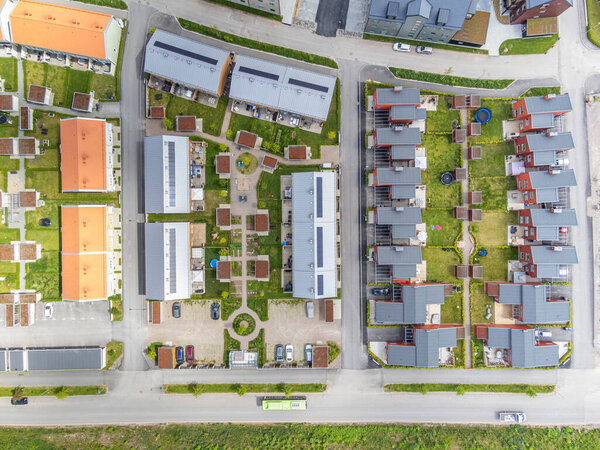 Image of A direct overhead aerial view above a vast residential neighbourhood, seen on a sunny day in the summer.