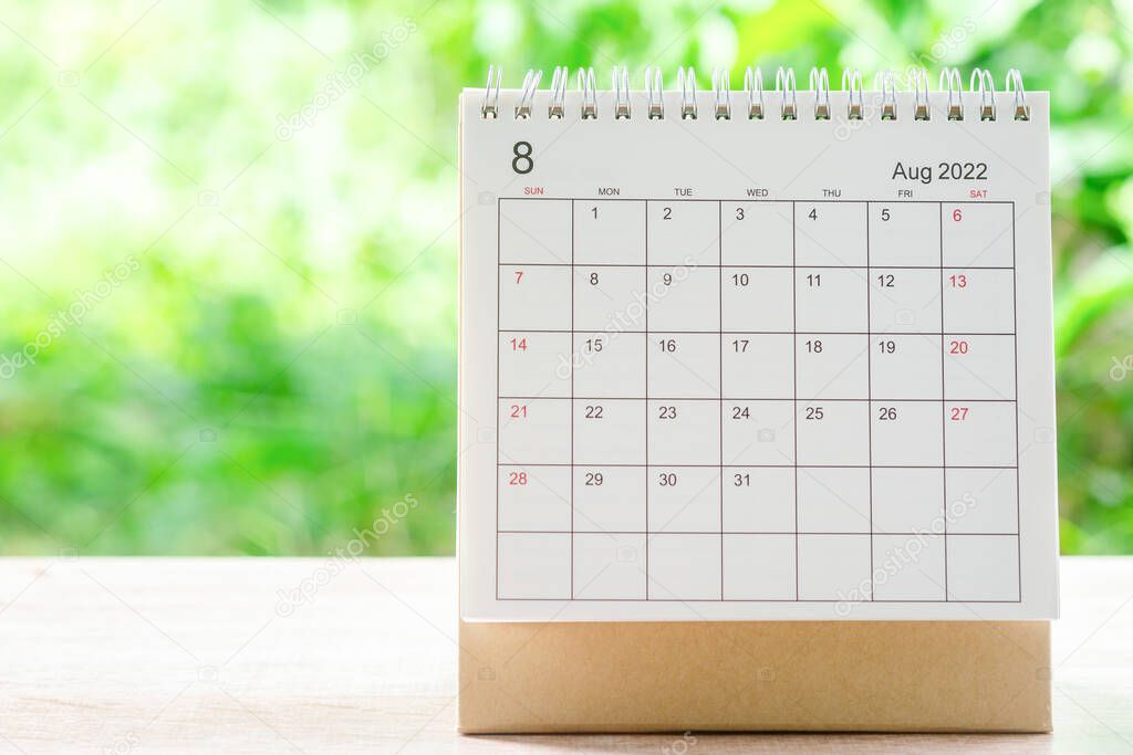 August month, Calendar desk 2022 for organizer to planning and reminder on wooden table with green nature background.