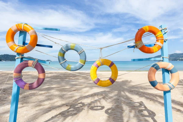 Artificial swim ring rubber on the beach with blue sky in summer at Patong Beach, Phuket Island, Thailand.