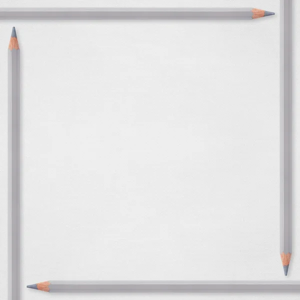 Белый бумажный фон с серыми карандашами — стоковое фото