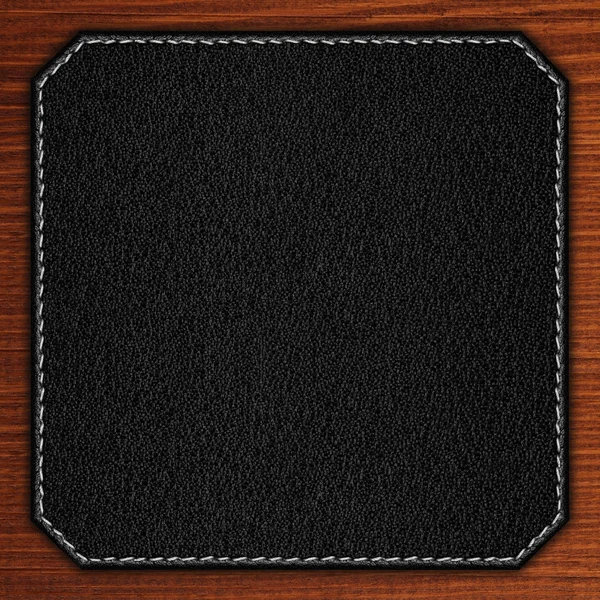 Fondo de cuero negro sobre textura de madera — Foto de Stock
