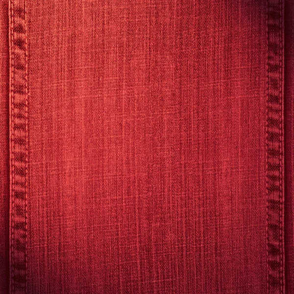 Красный фон джинсы — стоковое фото
