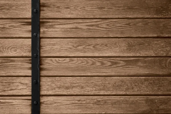 Wooden planks background with black metal bar — Stock Photo, Image