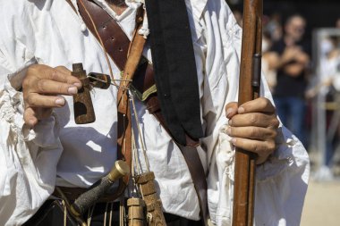 foreground hand showing the loading system of an arquebus. The arquebus was one of the weapons used by the Spanish thirds of Flanders. recreation of historical weapons