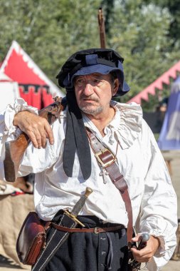 ALCALA DE HENARES, MADRID, SPAIN - OCTOBER 12, 2021:Man disguised as a soldier of the Spanish thirds posing with his weapons during the celebration of a medieval festival in alcala de henares