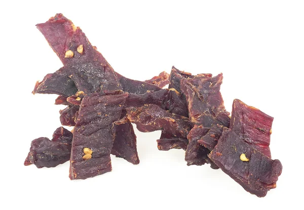 Pile Dried Spiced Beef Jerky Pieces Isolated White Background — стоковое фото