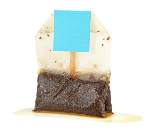 Used wet tea bag with tag isolated on a white background