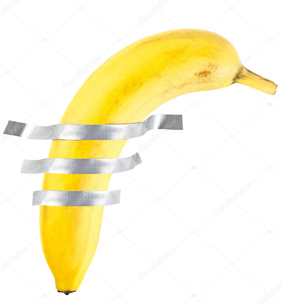 Banana duct taped to the white wall. Yellow banana on the white wall.
